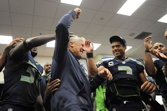 Pete Carroll informs the team that D.T. is not only going to be at the game, but has picked them to win.